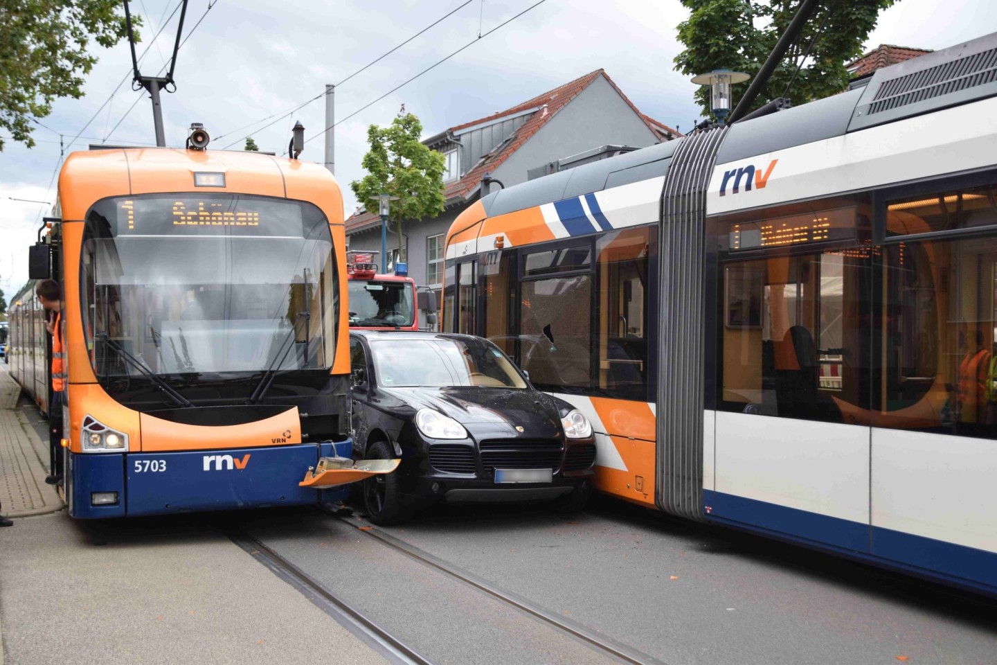 Ein Porsche ist nach einem leichtsinnigen Überholmanöver zwischen zwei Straßenbahnen eingeklemmt.